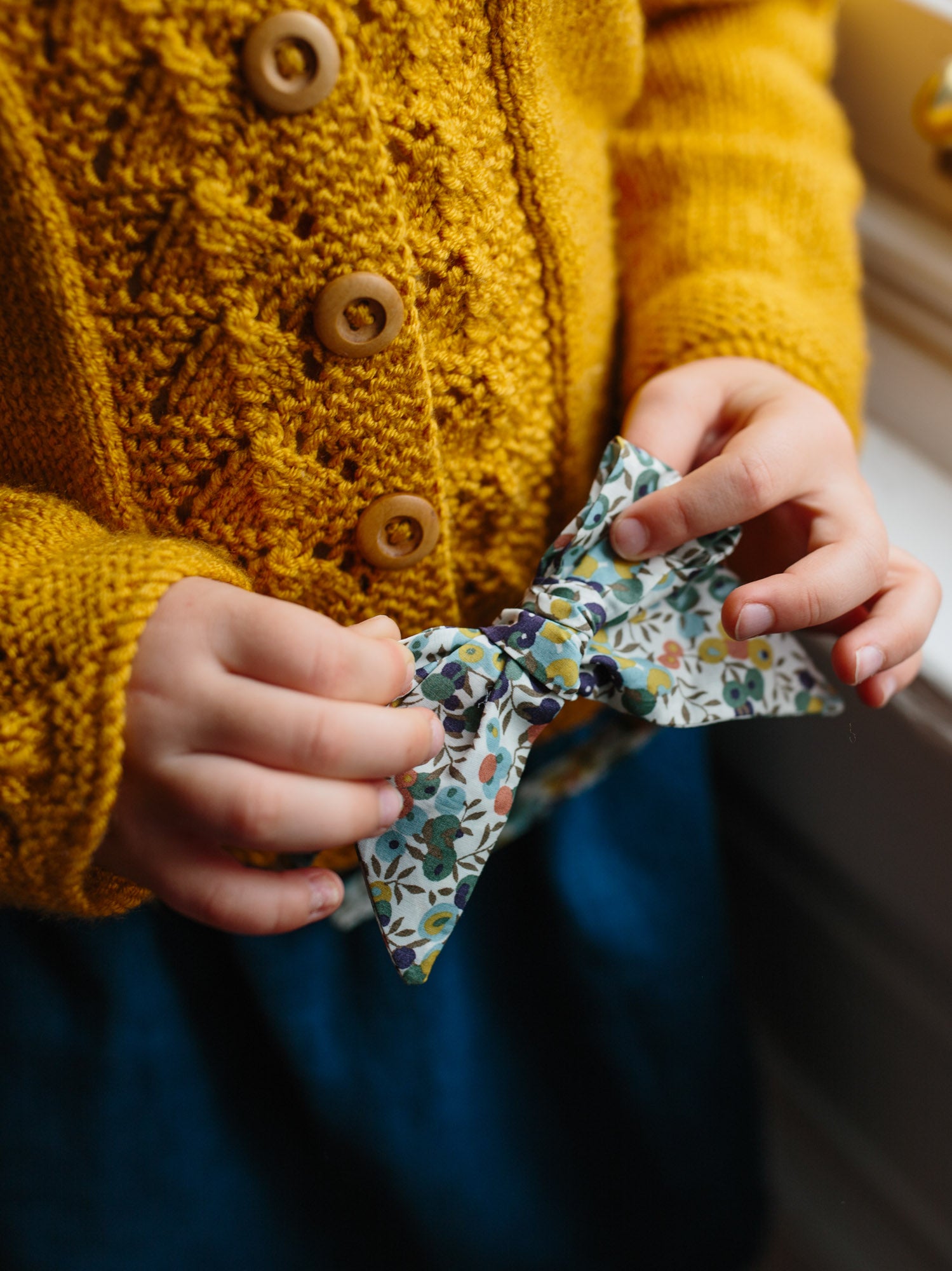 Girl holding her Liberty Print Bow