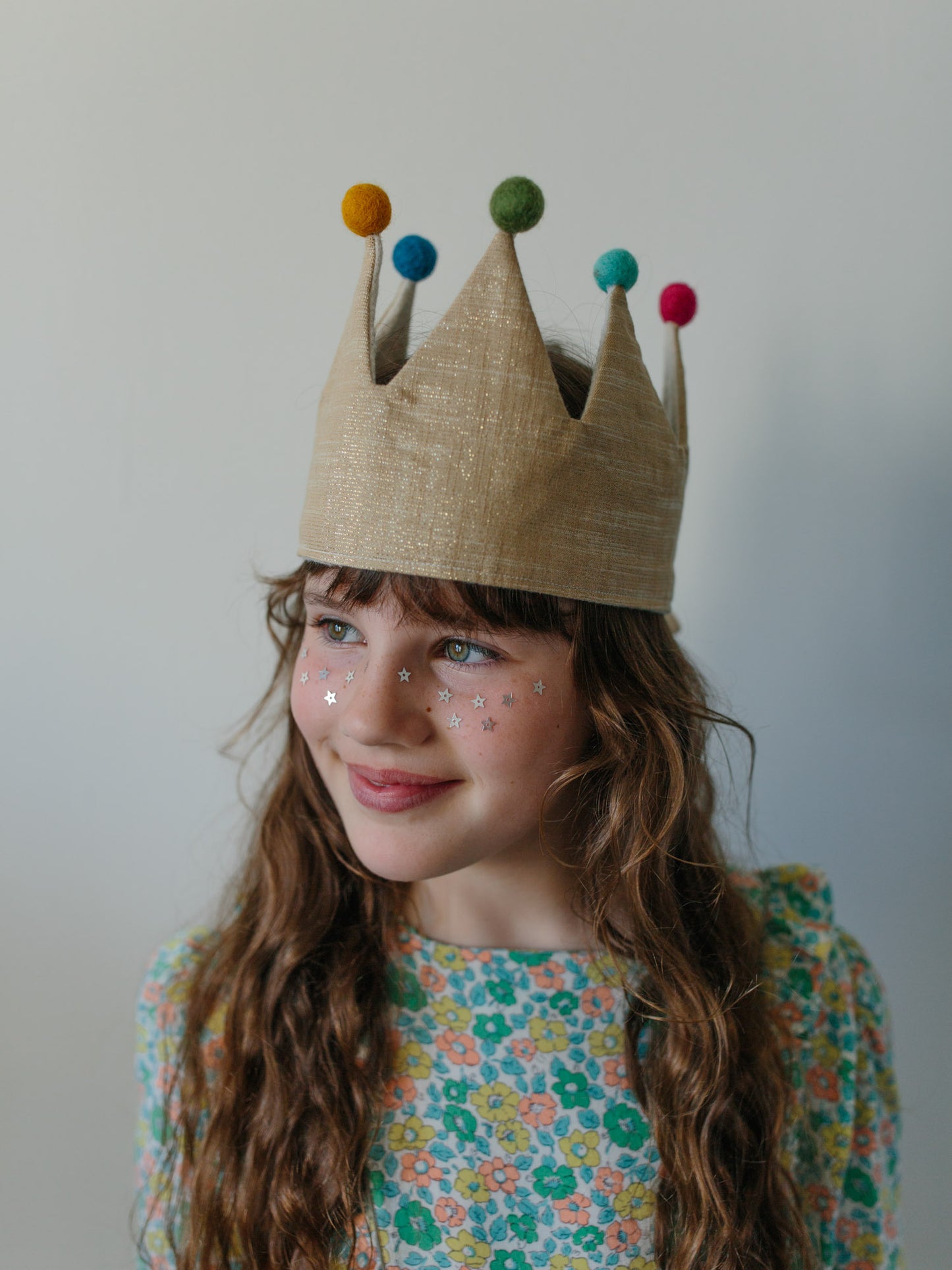 Grirlin her celebratory gold birthday crown