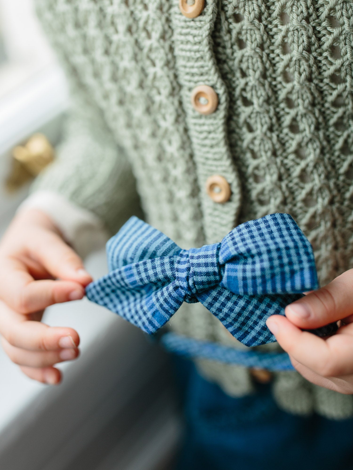close up of large bow alice band in winter blue